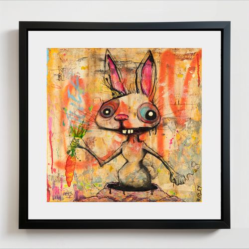 A framed surreal art print featuring a cartoonish rabbit holding a carrot, set against a colorful abstract background. The artwork is matted with white and enclosed in a black frame, shown hanging on a light gray wall.
