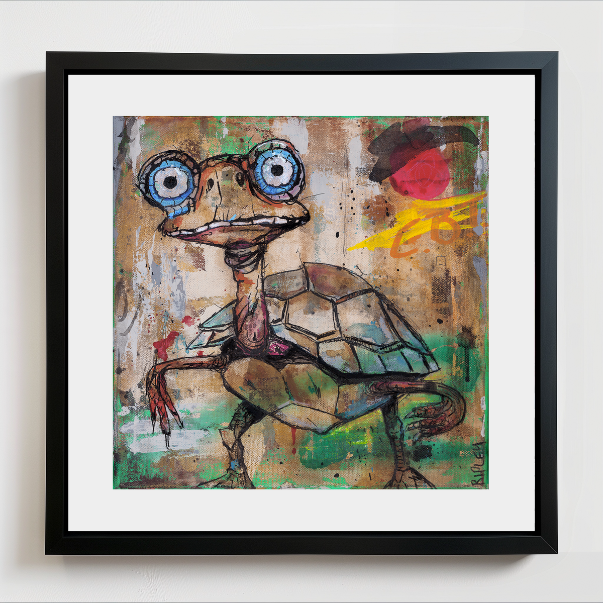 A framed square art print featuring a whimsical painted turtle with oversized blue eyes, a patterned shell, and expressive brushstrokes in earthy tones, shown against a white wall.