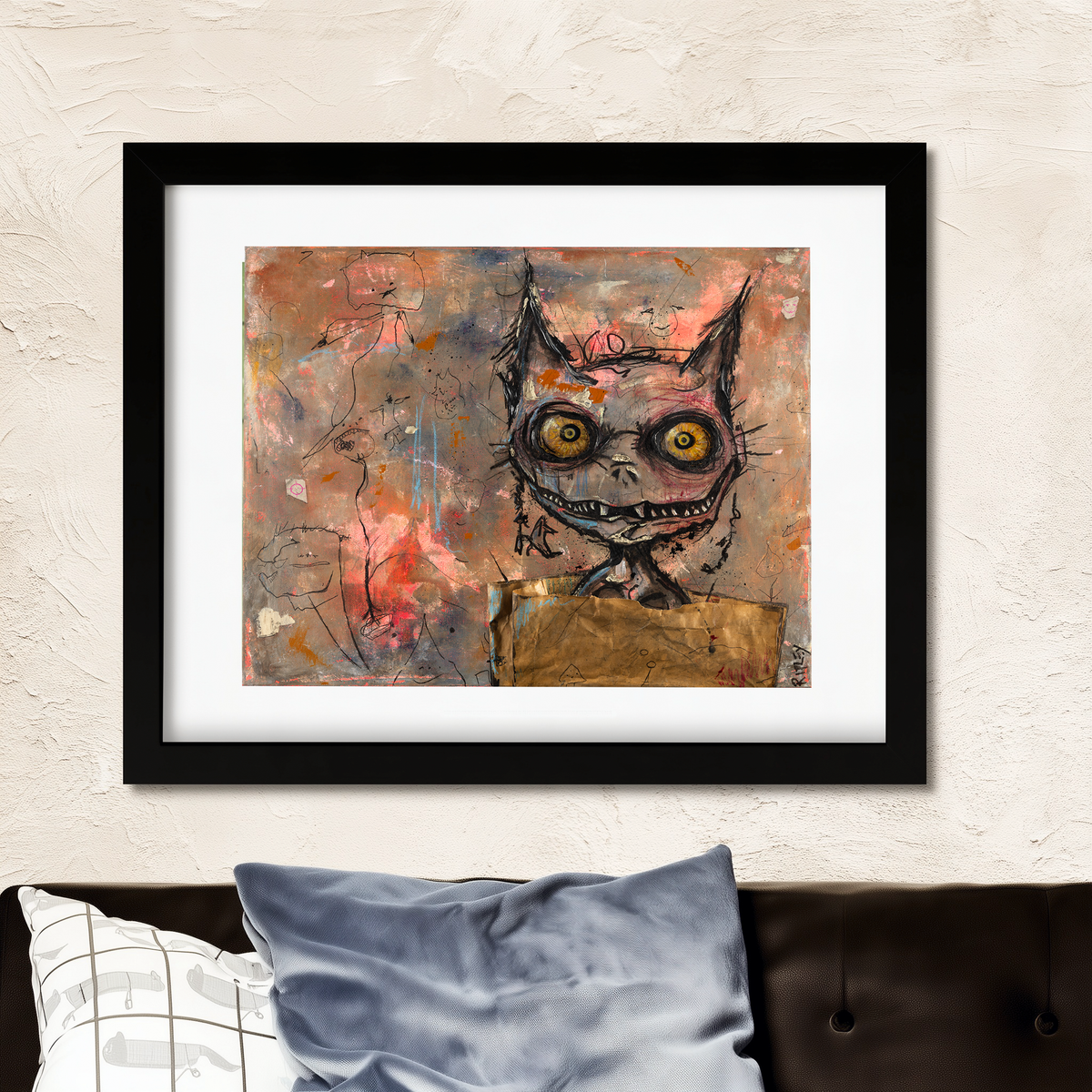Framed wall art featuring a surreal, sketch-style flea face with large yellow eyes and a stitched mouth, displayed above a sofa with pillows against a textured beige wall.
