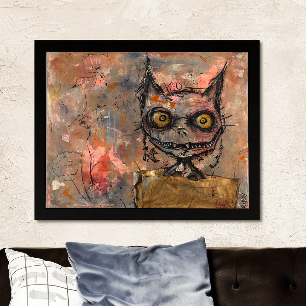 A framed abstract art print featuring a stylized flea-like face with large yellow eyes, displayed on a textured white wall above a dark sofa with pillows.