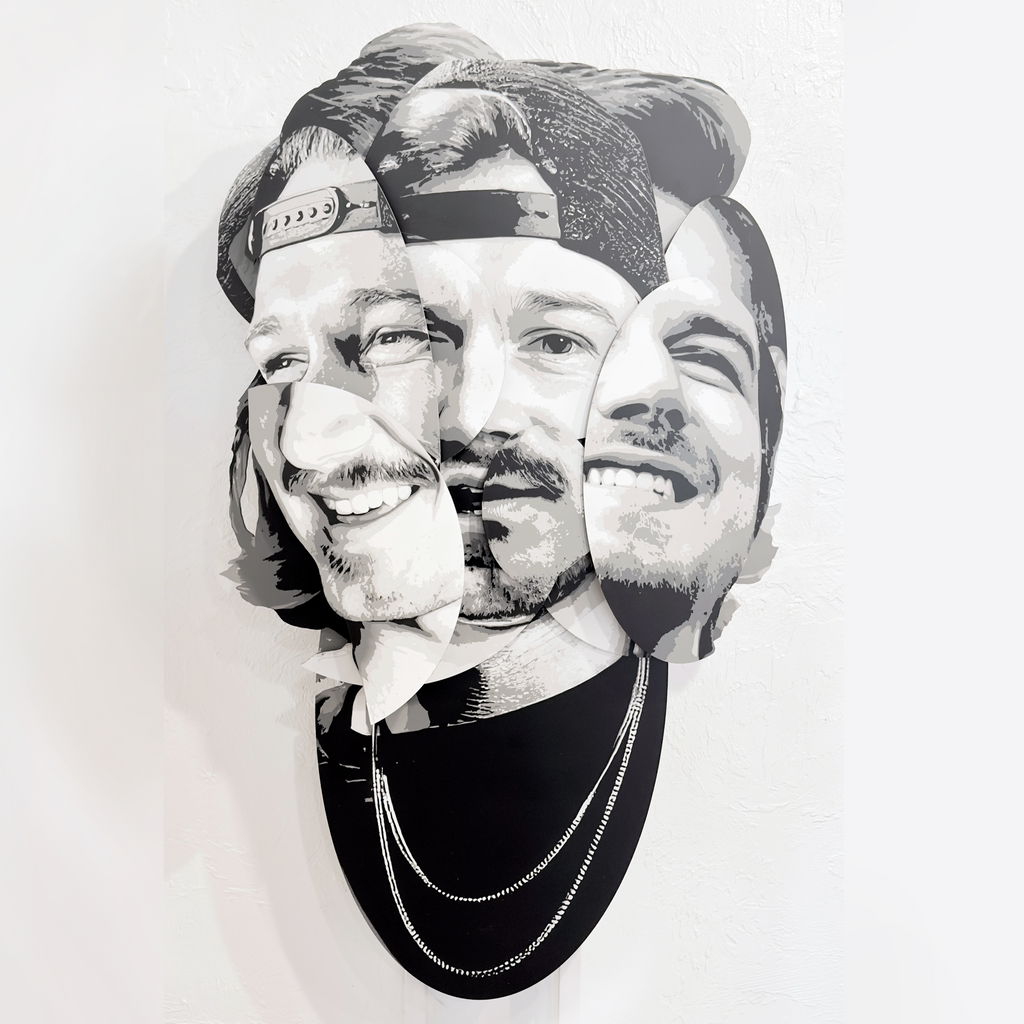 Parts of the Problem – dimensional spray paint artwork on layered wood by Ripley, inspired by Morgan Wallen, 41x24 inches.“Parts of the Problem by Ripley, a layered grayscale portrait of Morgan Wallen on a brick wall above a café table.”