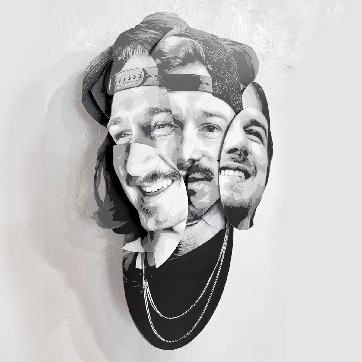 Parts of the Problem – dimensional spray paint artwork on layered wood by Ripley, inspired by Morgan Wallen, 41x24 inches. “Parts of the Problem by Ripley, a layered grayscale portrait of Morgan Wallen on a brick wall above a café table.”