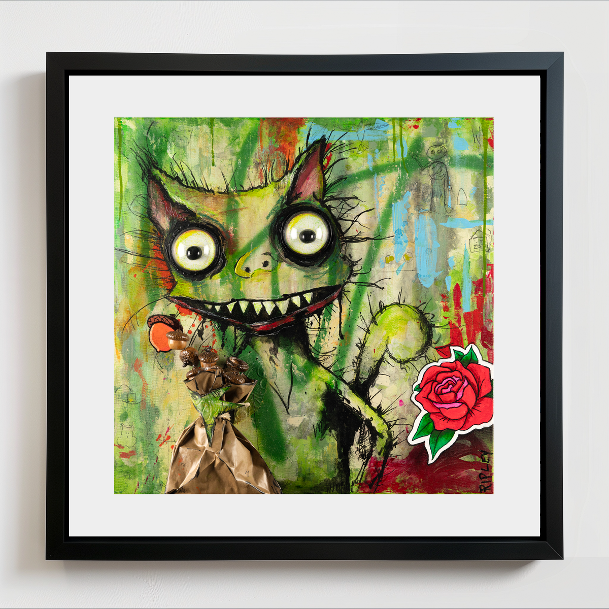 Framed wall art featuring a colorful graffiti-style illustration of a green squirrel with large eyes and a red rose in the lower right corner, shown against a white wall.