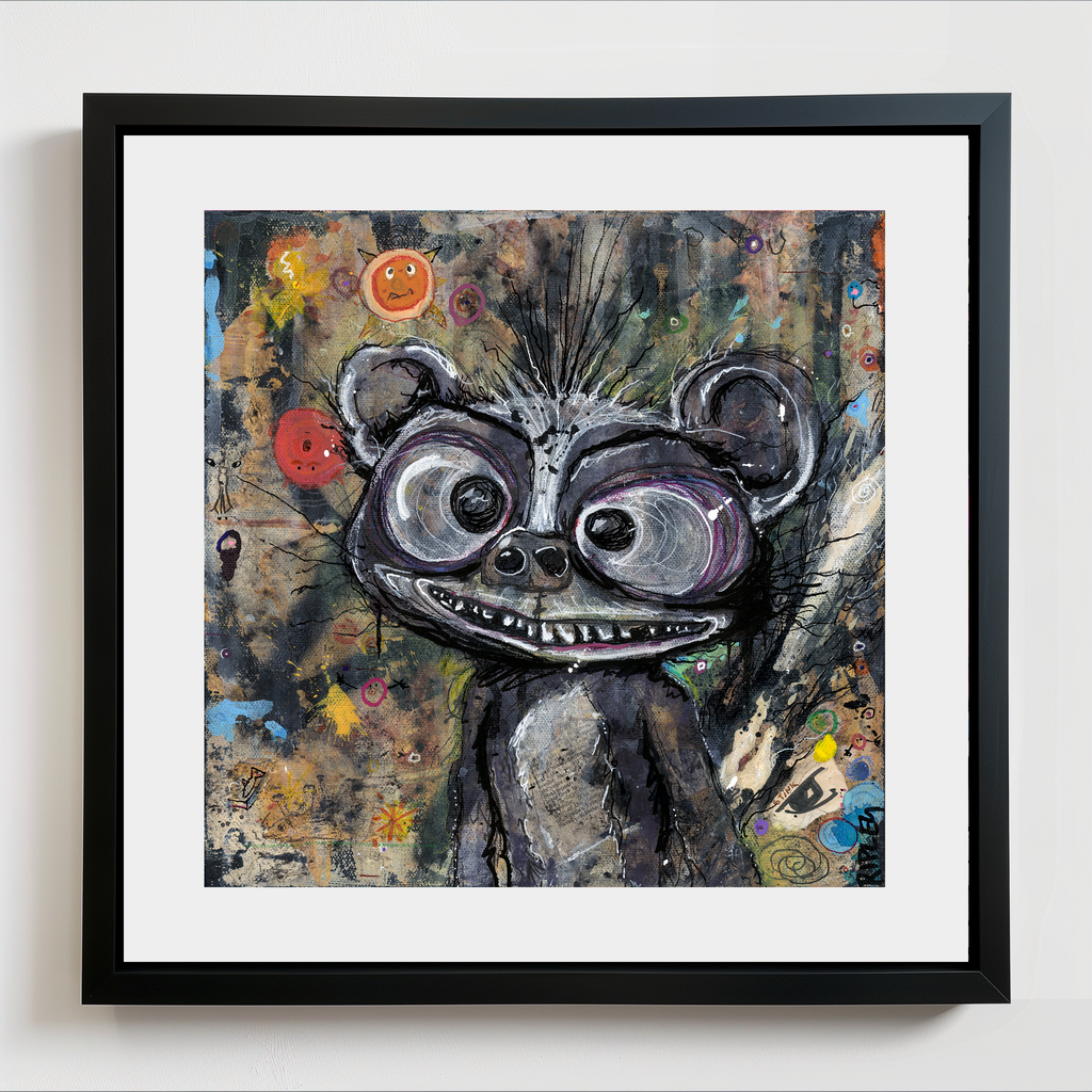 A framed art print featuring a whimsical, textured painting of a cartoon-like skunk with large eyes and a toothy grin, set against a dark, abstract background. The artwork is presented in a black frame with a white mat board, mounted on a light gray wall.