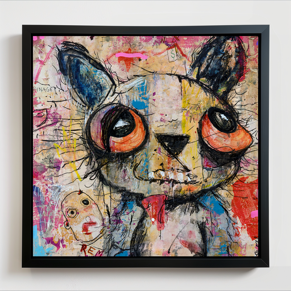 A framed square art print featuring a stylized, colorful Teddy bear illustration with large expressive eyes, black sketch lines, and layered paint splashes in pink, blue, red, yellow, and beige tones, shown hanging on a light wall.