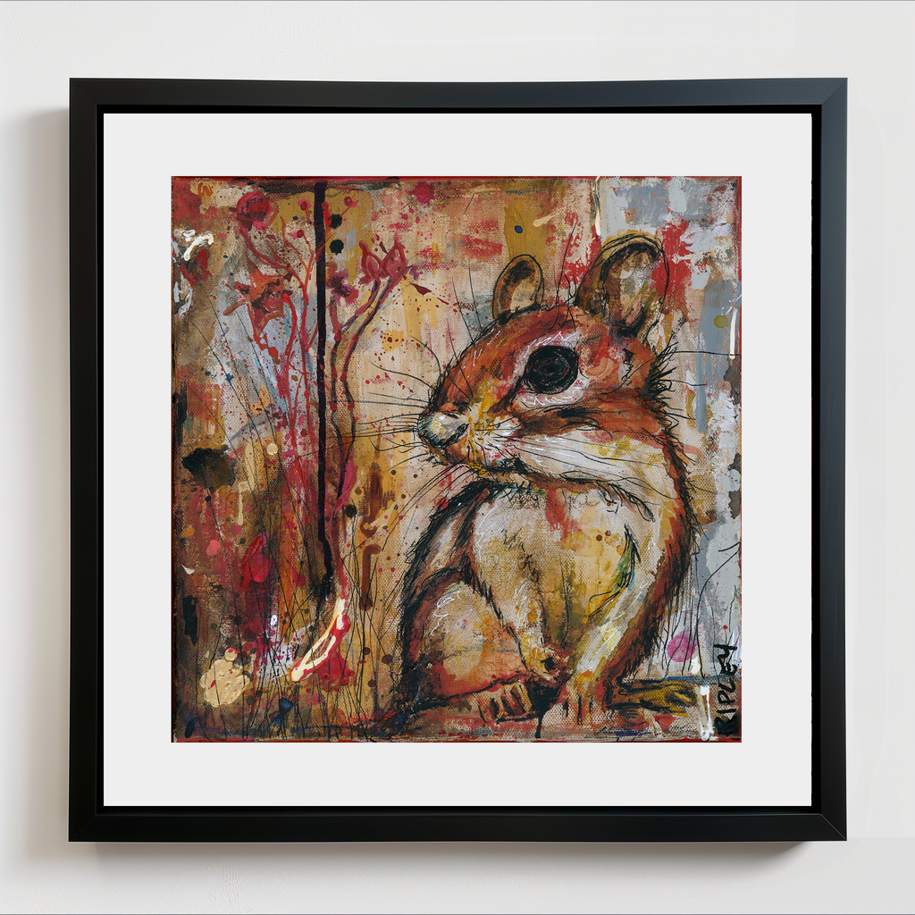 A framed art print featuring a painted chipmunk, set against an abstract multicolor background with red, yellow, and gray paint splatters. The artwork is matted with a wide white border and enclosed in a simple black frame, shown hanging on a light gray wall.